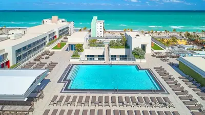 an aerial view of a resort with a swimming pool and the ocean at Ocean View Stay with Rooftop Pool Near the Beach in Hollywood