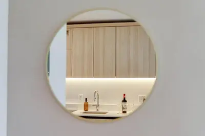 a mirror reflecting a sink in a bathroom at Sky Corner Residence- Pool Parking Amenities in Miami