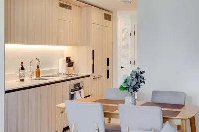 a kitchen and dining room with a table and chairs at Sky Corner Residence- Pool Parking Amenities in Miami