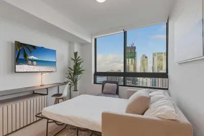 a bedroom with a bed and a desk and a window at Miami Skyline 1BR Sleeps 4 with Elite Amenities in Miami