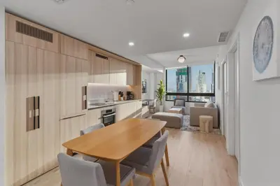 a kitchen and dining room with a table and chairs at Miami Skyline 1BR Sleeps 4 with Elite Amenities in Miami