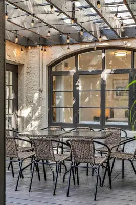 a patio with a table and chairs on a patio at Spacious & Stylish 2BR Retreat near Victoria Park in Fort Lauderdale