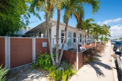 a house with palm trees on a street at Vista Del Mar - by Atlantikos in Hollywood
