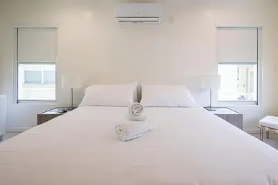 a bedroom with a large white bed with a towel on it at Vista Del Mar - by Atlantikos in Hollywood