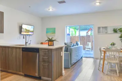 a kitchen and living room with a couch and a table at Spacious Entire Duplex for Family Stay in Miami