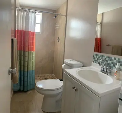 a bathroom with a toilet and a sink and a shower at Le Cartier 207 STR-02440 in Sunny Isles Beach