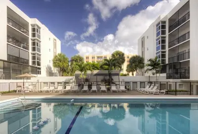 an image of a swimming pool in front of two buildings at Le Cartier 207 STR-02440 in Sunny Isles Beach