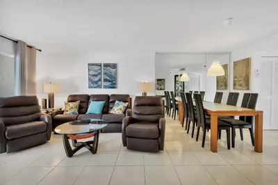 a living room with a table and a dining room at Le Frontenac 204 STR-01054 in Sunny Isles Beach