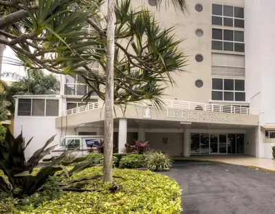a palm tree in front of a building at Le Frontenac 204 STR-01054 in Sunny Isles Beach