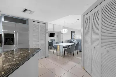 a kitchen and dining room with a table and chairs at Le Frontenac 413 STR-03005 in Sunny Isles Beach