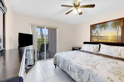a bedroom with a bed and a flat screen tv at Le Frontenac 413 STR-03005 in Sunny Isles Beach