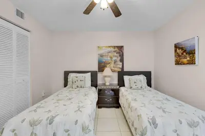 a bedroom with two beds and a ceiling fan at Le Frontenac 413 STR-03005 in Sunny Isles Beach