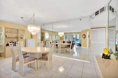 a kitchen and dining room with a table and chairs at Le Frontenac 414 STR-01532 in Sunny Isles Beach