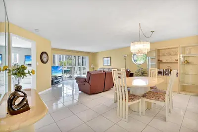 a dining room and living room with a table and chairs at Le Frontenac 414 STR-01532 in Sunny Isles Beach