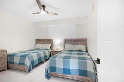 a bedroom with two beds and a ceiling fan at Le Golden Bay 902 STR-00876 in Sunny Isles Beach