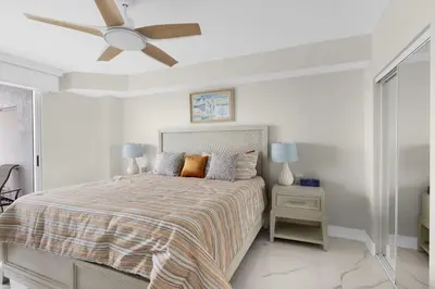 a bedroom with a bed with a ceiling fan at Le Golden Bay 902 STR-00876 in Sunny Isles Beach