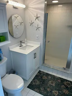 a bathroom with a toilet and a sink and a shower at Le Laurier in Sunny Isles Beach