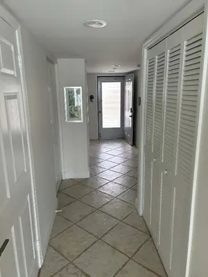 a hallway with a door and a tile floor at Le Laurier in Sunny Isles Beach