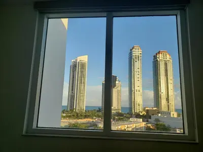 a window view of a city skyline with tall buildings at Le Marina Bay 1001 STR-01504 in Sunny Isles Beach