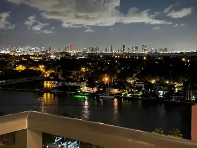 a view of a river with a city at night at Penthouse Condo - Oceanfront - Miami Beach - sleeps 8 in Miami Beach