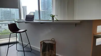 a bar with a chair and a laptop on a counter at Brickell Condo, with FREE parking in Miami