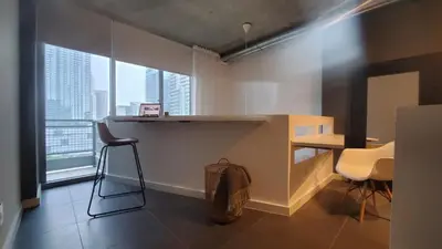 a room with a desk and a table and chairs at Brickell Condo, with FREE parking in Miami