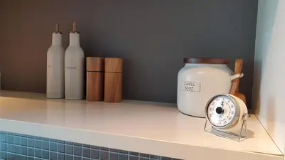 a counter with bottles and a clock on a shelf at Brickell Condo, with FREE parking in Miami