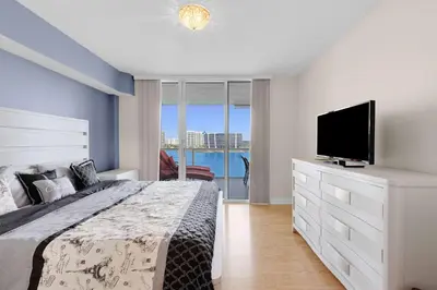 a bedroom with a large bed and a television at Le Marina Bay 1106 STR-03006 in Sunny Isles Beach