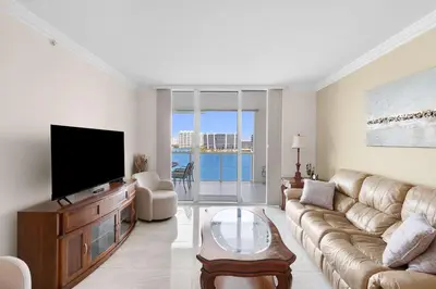 a living room with a couch and a flat screen tv at Le Marina Bay 1106 STR-03006 in Sunny Isles Beach