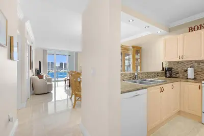 a kitchen with a sink and a living room at Le Marina Bay 1106 STR-03006 in Sunny Isles Beach