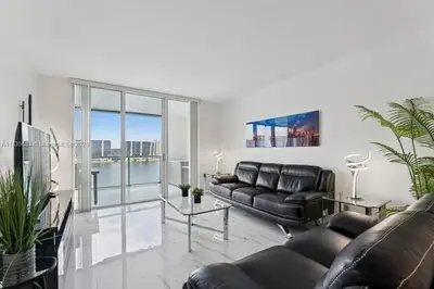 a living room with a couch and a table at Marina Bay Club STR-0 in Sunny Isles Beach