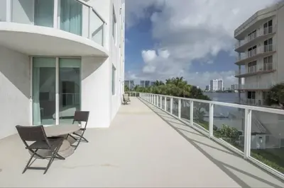 a balcony with a table and chairs on a building at Le Marina Bay 310 STR-01478 in Sunny Isles Beach