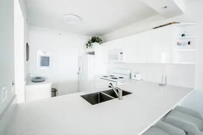 a white kitchen with a sink and a counter at Le Marina Bay 310 STR-01478 in Sunny Isles Beach