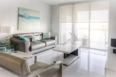 a living room with a couch and a table at Le Marina Bay 407 STR-01404 in Sunny Isles Beach