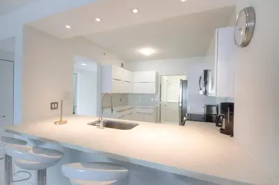 a white kitchen with two toilets and a sink at Le Marina Bay 407 STR-01404 in Sunny Isles Beach