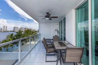 a balcony with a table and chairs on a balcony at Le Marina Bay 409 STR -02439 in Sunny Isles Beach