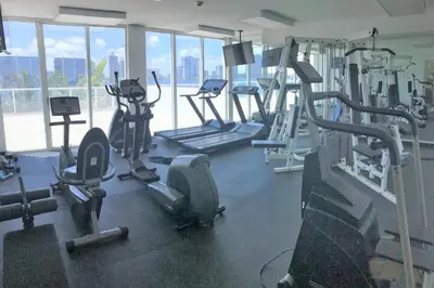 a gym with several treadmills and elliptical machines at Le Marina Bay 409 STR -02439 in Sunny Isles Beach