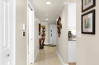 a hallway of a home with white walls at Le Marina Bay 603 STR-02736 in Sunny Isles Beach