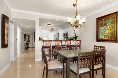 a dining room and kitchen with a table and chairs at Le Marina Bay 603 STR-02736 in Sunny Isles Beach