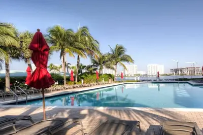 a red dress is on a pole next to a swimming pool at Le Marina Bay 603 STR-02736 in Sunny Isles Beach