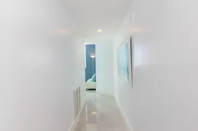 a hallway with white walls and a picture on the wall at Le Marina Bay 801 STR-01477 in Sunny Isles Beach