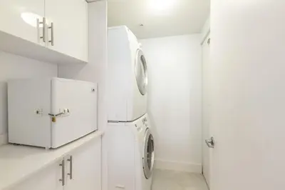 a white laundry room with a washer and dryer at Le Marina Bay 801 STR-01477 in Sunny Isles Beach