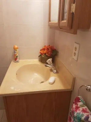 a bathroom with a sink with a flower arrangement on it at Le Marbella 303 STR-02828 in Sunny Isles Beach