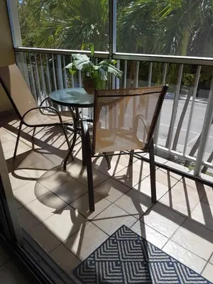 a balcony with a table and a chair on a porch at Le Marbella 303 STR-02828 in Sunny Isles Beach