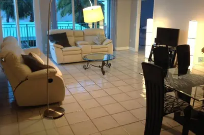 a living room with two couches and a glass table at Le Montcalm 102 STR-01921 in Sunny Isles Beach