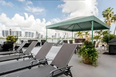 a group of chairs and an umbrella on a roof at Le Montcalm 102 STR-01921 in Sunny Isles Beach