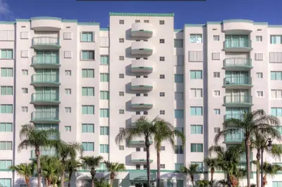 a large white building with palm trees in front of it at Le Montcalm 303 STR-01919 in Sunny Isles Beach