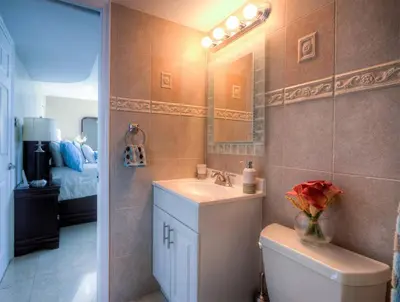 a bathroom with a sink and a toilet and a mirror at Le Montcalm 601 STR-01927 in Sunny Isles Beach