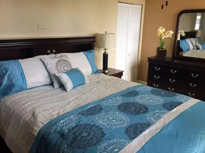 a bedroom with a large bed and a dresser with a mirror at Le Montcalm 601 STR-01927 in Sunny Isles Beach