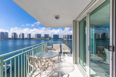 a balcony with a table and chairs and the water at Le Montcalm 804 STR-01923 in Sunny Isles Beach